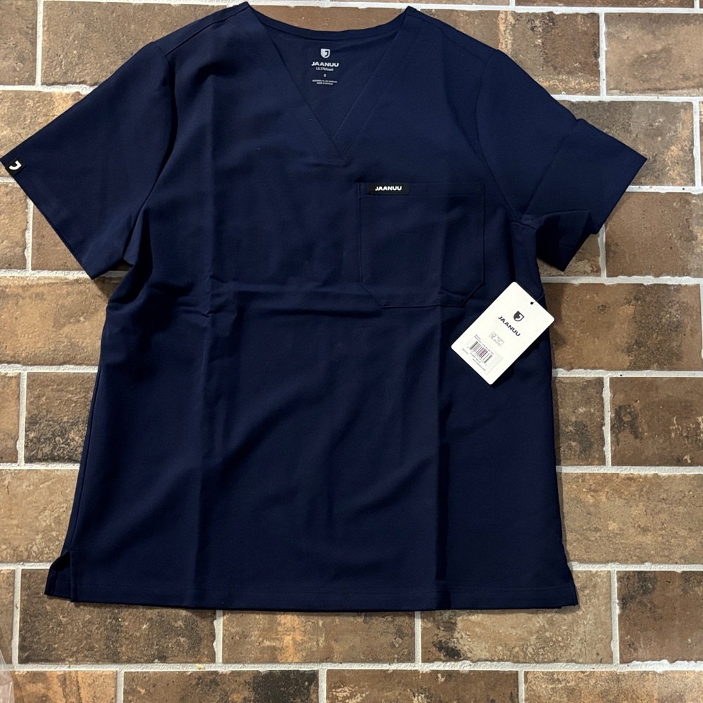 Jaanuu Navy 1 pocket Scrub Top  NEW with tags size small